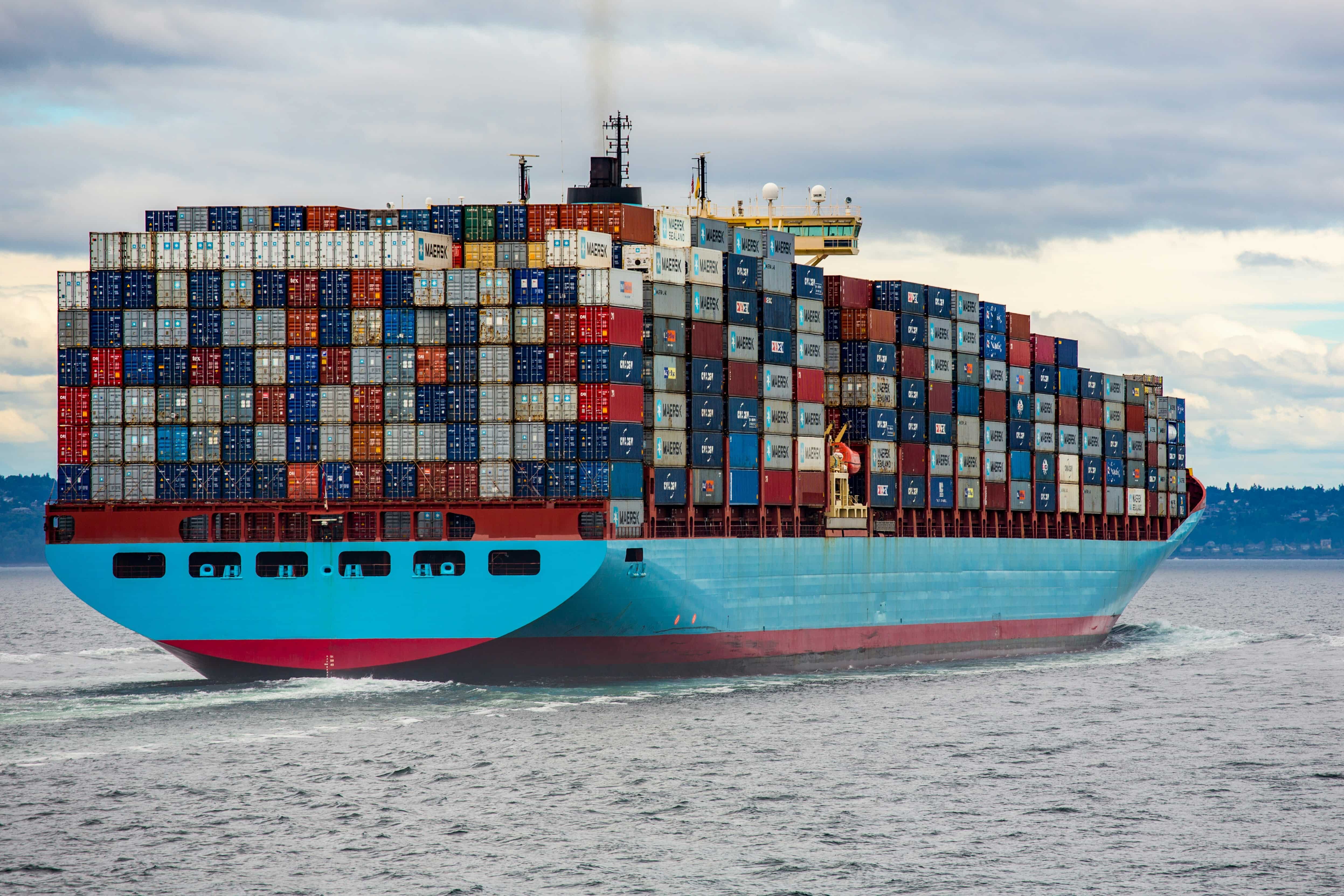 A large ship stacked with colorful shipping containers.