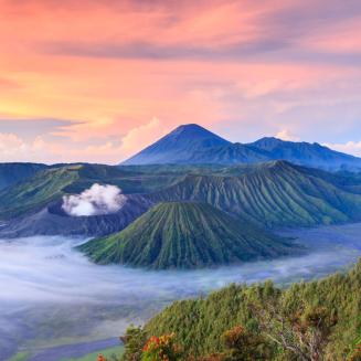 A range of mountains rising above the mist in Indonesia which is so stunningly beautiful, it honestly looks like someone drew it