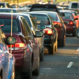 A whole bunch of cars stuck in a miserable traffic jam