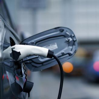 An electric vehicle plugged in and charging