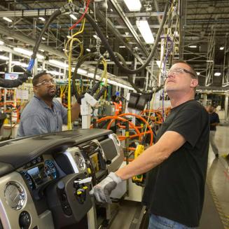Auto workers inside a plant.
