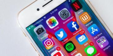 An iPhone showing social media icons on the home screen