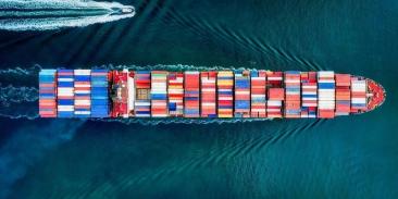 A large ship filled with shipping containers at sea