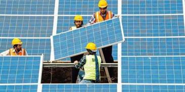 Workers install solar panels