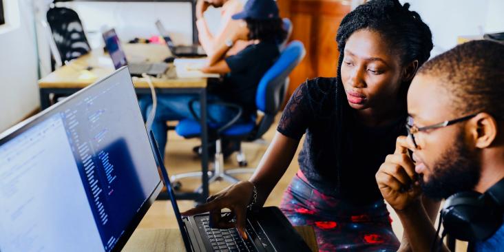 Black men and women working at computers in an office