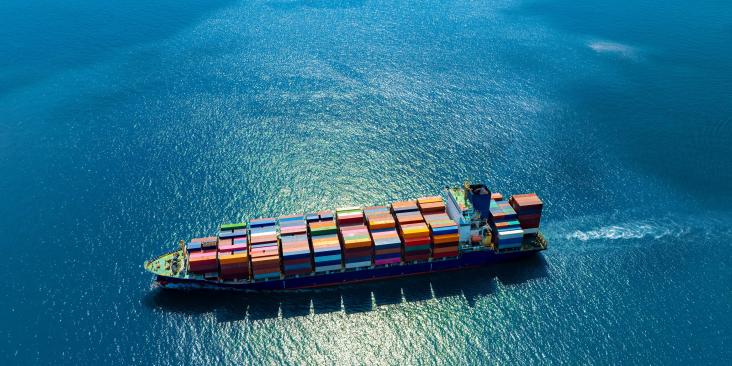 Aerial view of a container ship on the open sea.