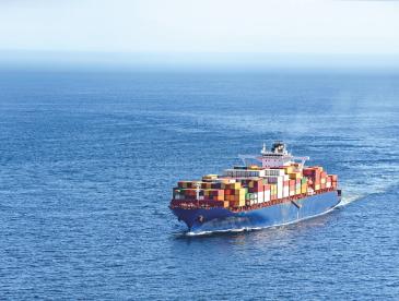A shipping boat traveling through the ocean.
