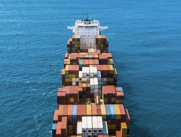 Cargo ship on water, viewed from above.