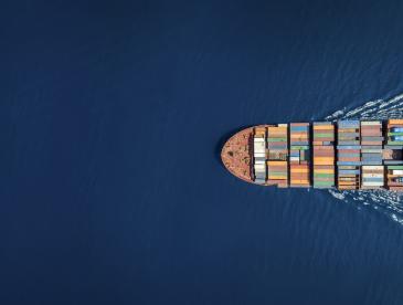Cargo ship traveling on open water.