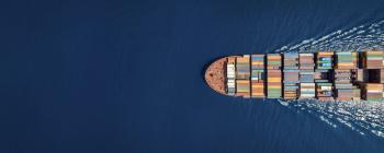 Cargo ship traveling on open water.