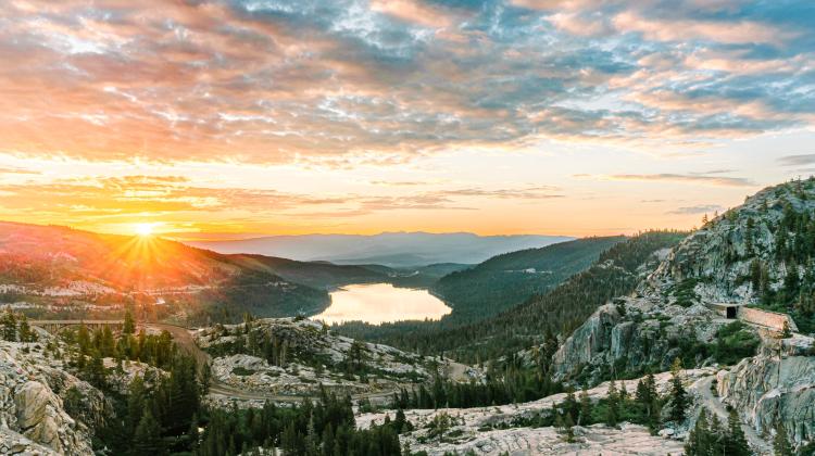 Sun rising or setting over a beautiful mountain landscape.